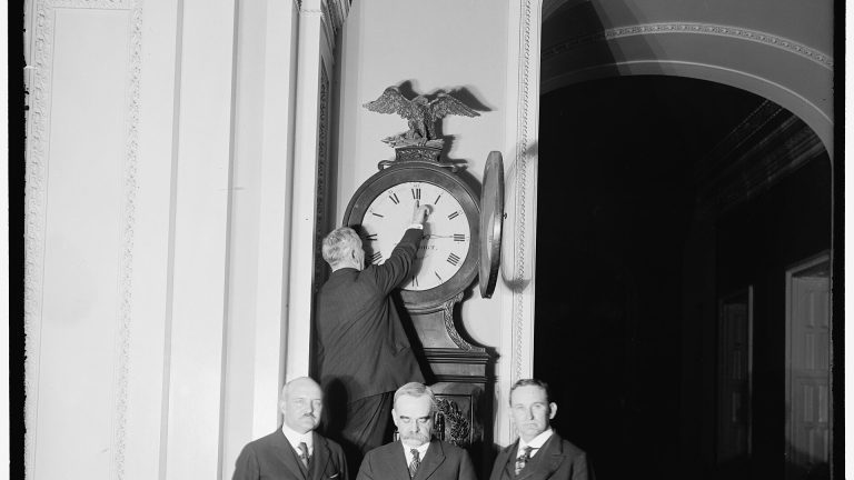 A Senate official turns the hands of the Ohio Clock forward for the first daylight saving time in 1918